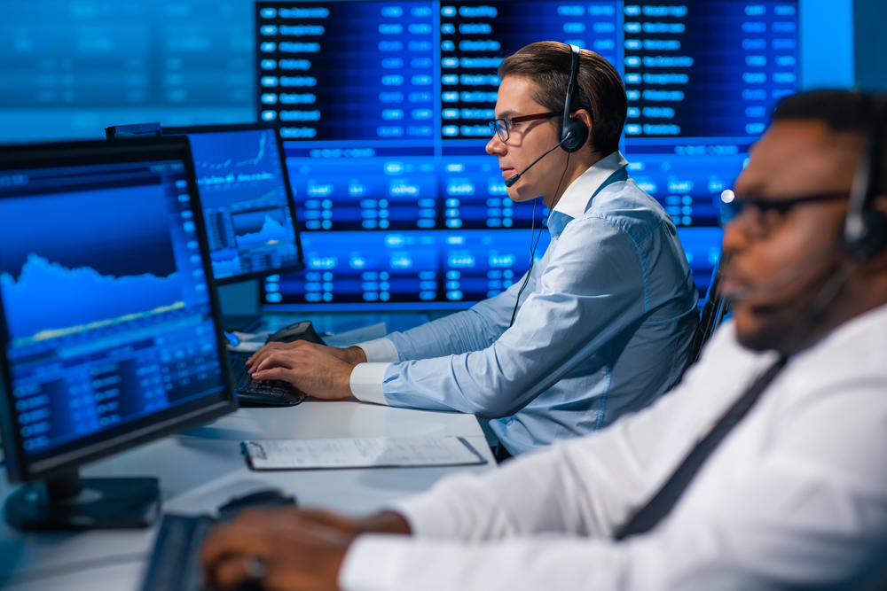 Team,Of,Brokers,Is,Working,In,Office,Using,Workstation,And